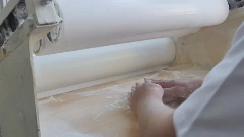 The production process of Armenian lavash in a bakery. The baker makes pita Stock Footage 192338300