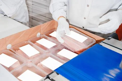 Production process, packaging on the conveyor line of meat in boxes.Conveyor Stock Photos