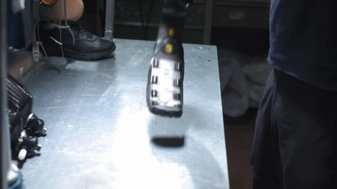 Production of a prosthetic leg. A man creates part of the leg. An engineer is Stock Footage 120153850