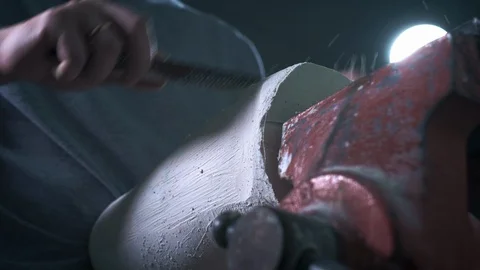 Production of a prosthetic leg. A person processes a plaster cast of a part of Stock Footage 120131876