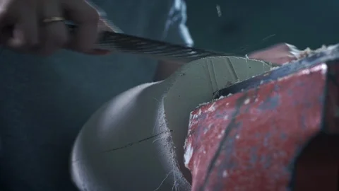 Production of a prosthetic leg. A person processes a plaster cast of a part of Stock Footage 120132405