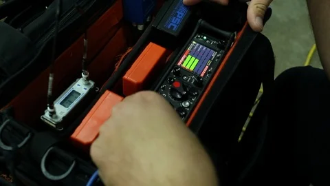 Production sound mixer with hands on levels on tv film set Stock Footage 125635315