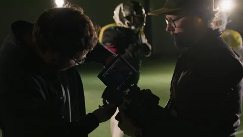 Production Technician Changing Lens on Camera on Set of Football Show Stock Footage 335395307