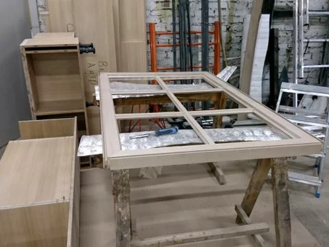 Production of a window frame in a carpentry shop Stock Photos