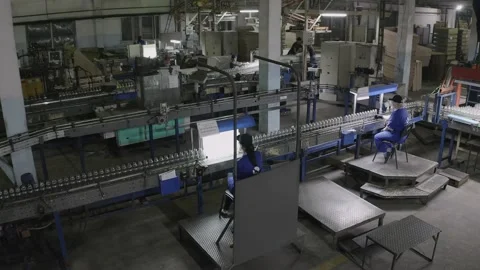 Production worker selectively examines quality of the bottles, working conveyor Video stock 149980317