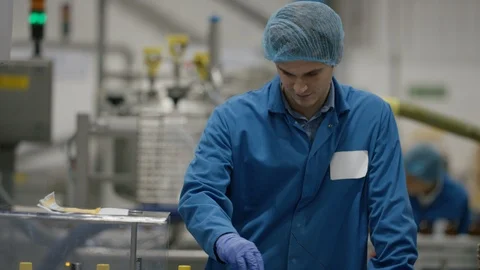 Production worker smiling at camera while working at production line Stock Footage 107996500
