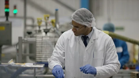 Production worker smiling at camera while working at production line Stock Footage 107997106