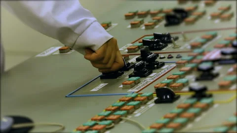 The production worker turns the handle of the machine to adjust the machine Stock-Footage 93272950