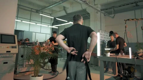 The production worker wears a protective apron before starting a work shift Stock Footage 179686460