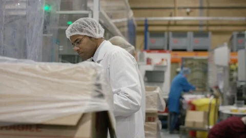 Production workers checking bottles and carrying tray in cosmetic factory Stock Footage 107955453