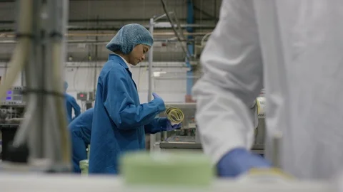 Production workers checking packaging and labels in cosmetic factory Stock Footage 107958341