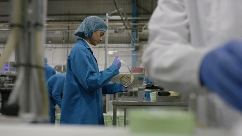 Production workers checking packaging and labels in cosmetic factory Stock Footage 107958722
