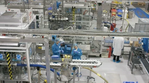 Production workers working on production line in cosmetic factory Stock Footage 107966621