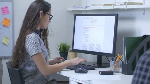 Productive female worker in front of a large computer monitor Stock Footage 142243826