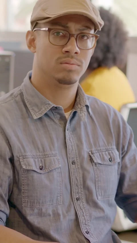 Productive man using computer and then smiling in a coworking 스톡 동영상 264390453