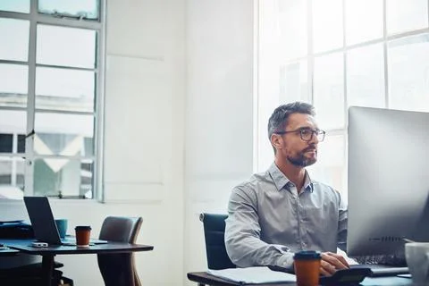 Productivity is his top priority each day. a mature businessman working on a Stock Photos