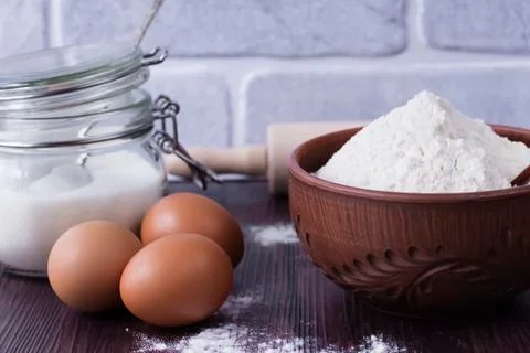 Products and objects for baking chocolate cake on dark wooden table. Concept Stockfoto's