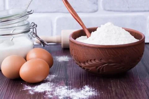Products and objects for baking chocolate cake on dark wooden table. Concept Stock Photos