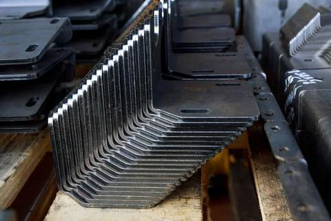 Products bent on a bending machine, close-up. Factory made metal parts. Stock Photos
