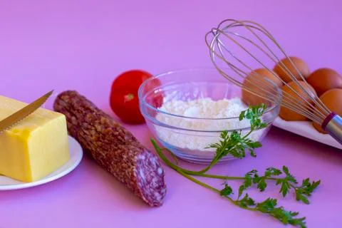 Products for cooking pizza or pies. Eggs, flour, tomato, cheese, salami Stock Photos