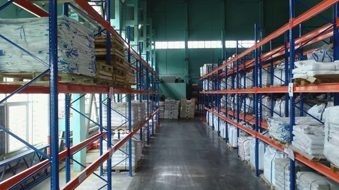 Products at the warehouse. Horizontal camera move between the rows shelves. Stock Footage 124038640