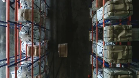 Products at the warehouse. Horizontal camera move between the rows shelves. Stock Footage 124038739