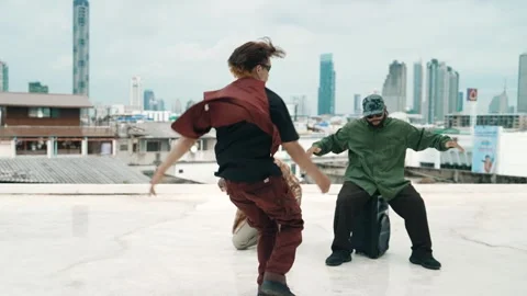 Profession break dancer practice B-boy dance with friends at roof top. hiphop. Stock Footage 274786487