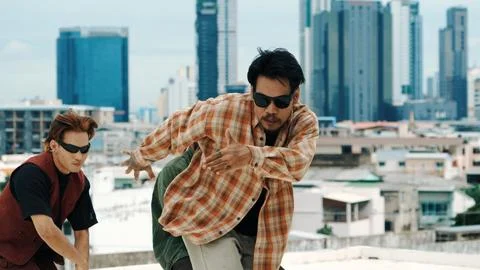Profession break dancer practice B-boy dance with friends at roof top. Endeavor. Stock Photos