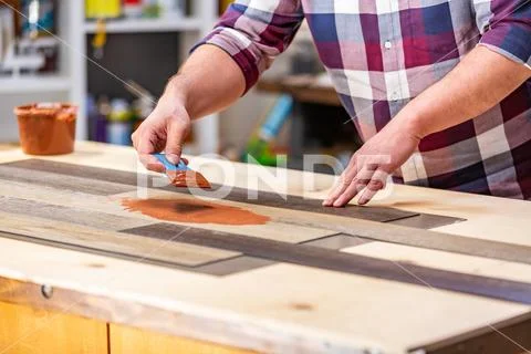 Profession, carpentry, woodwork and people concept - carpenter working with wood Stock Photos