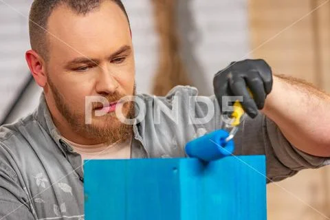 Profession, carpentry, woodwork and people concept - carpenter working with wood Stock Photos