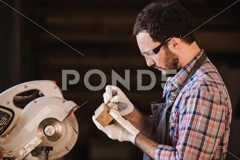 Profession, carpentry, woodwork people concept - carpenter with wood plank and Stock Photos