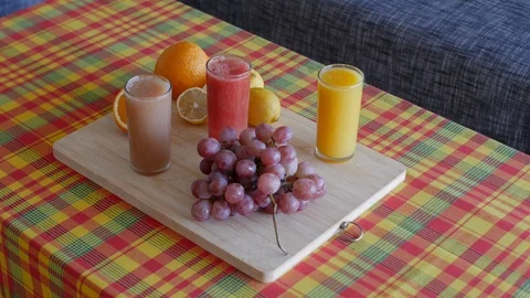 Professional 4K View of fruit and juices platter on Caribbean madras style table Stock Footage 112029446