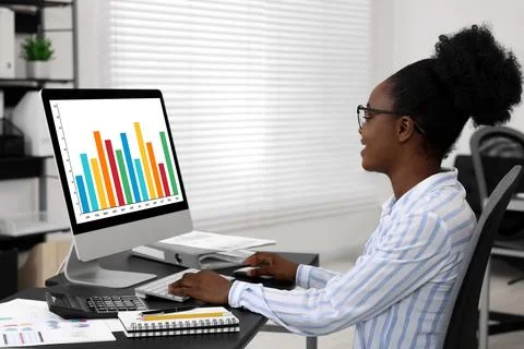 Professional accountant working on computer at desk in office Stock Photos