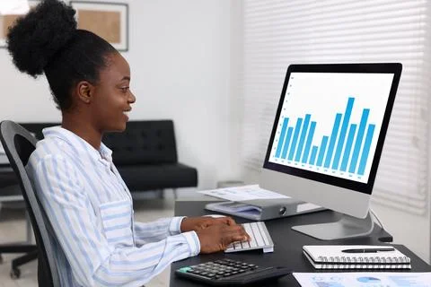 Professional accountant working on computer at desk in office Stock Photos
