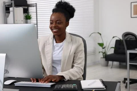Professional accountant working on computer at desk in office. Space for text Stock Photos