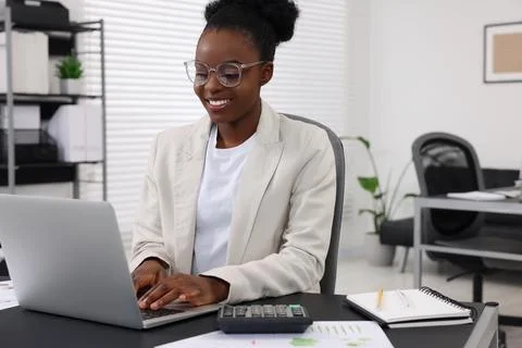 Professional accountant working on computer at desk in office Stock Photos