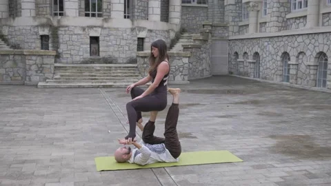 Professional acrobatic yoga. couple practising acro exercises on mat outdoors Stock-Footage 150661182