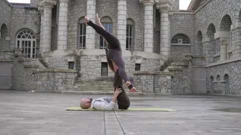 Professional acrobatic yoga. couple practising acro exercises on mat outdoors Video stock 150661244