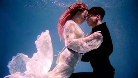 A professional actor and actress dancing under the water, a couple are shot in a Stock Footage 89451620