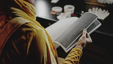 Professional actor flips through script of show at table Stock Footage 192397360