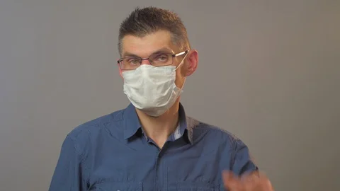 Professional actor in glasses shows disposable mask Stock Footage 129304876