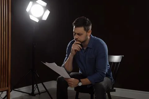 Professional actor reading his script during rehearsal in theatre Stock Photos