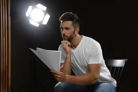 Professional actor reading his script during rehearsal in theatre Stock Photos