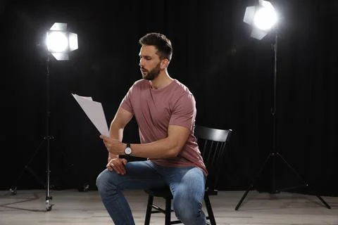 Professional actor reading his script during rehearsal in theatre Stock Photos