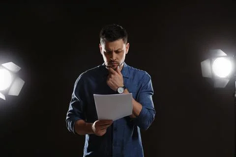 Professional actor reading his script during rehearsal in theatre Stock Photos