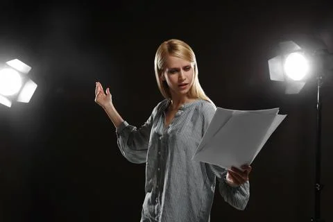 Professional actress reading her script during rehearsal in theatre Stock Photos