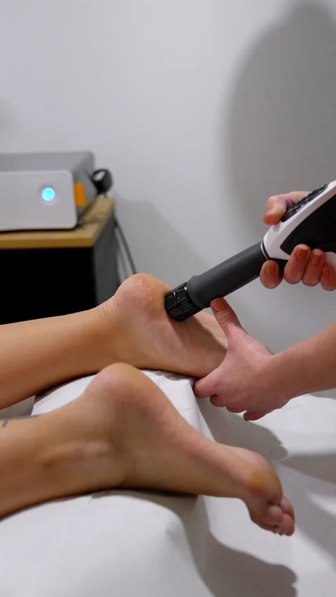 Professional Administering Shockwave Therapy on Heel for Heel Pain Stock Footage 271351159