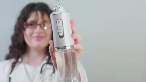 Professional advice orthodontist recommends using an irrigator to fight plaque Stock Footage 307303375