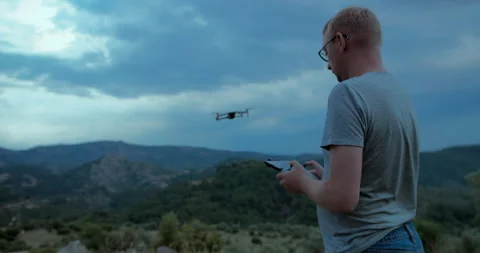 Professional aerial pilot control drone in wild nature Stock Footage 248057208
