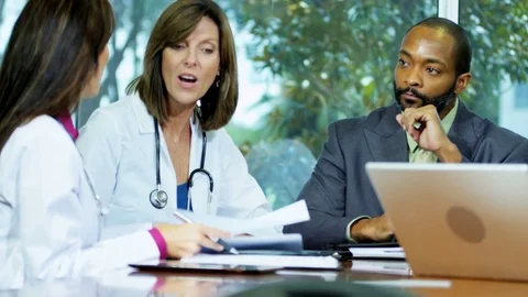 Professional African American male hospital chief executive meeting medical Stock Footage